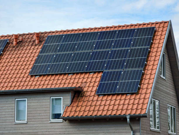 Southside solar panel services in Armadale Modern large single-family house large solar modules on red roof tiles