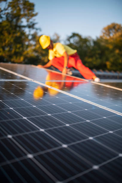 Solar panel installation in Serpentine Vertical Shot Of Construction Worker Installing Solar Panel