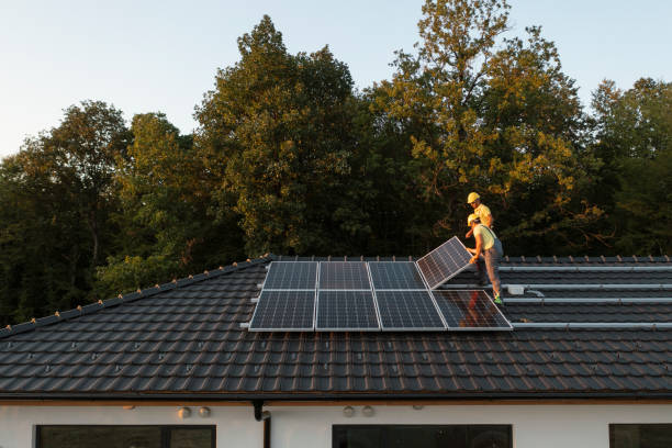 Solar panel system in Mundijong Two Professionalists Installing Solar Panels On A Roof Of A Modern House