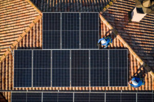 aerial view of Two workers installing solar panels on a house roof - Southside Solar and Electrical Solar Power Perth